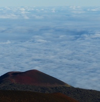 Red cinder cone in front of cloud bank